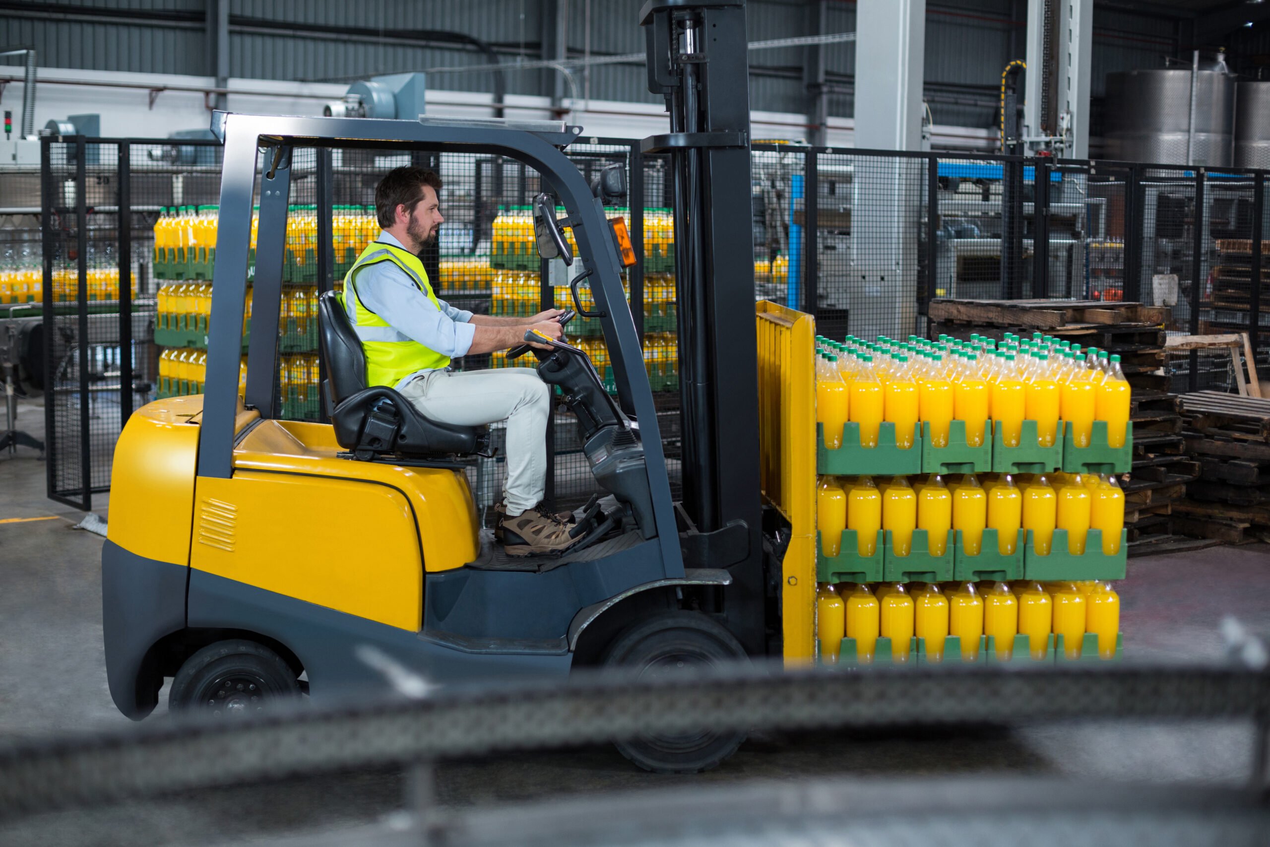 factory-worker-loading-packed-juice-bottles-in-progrss-managed-database-environment